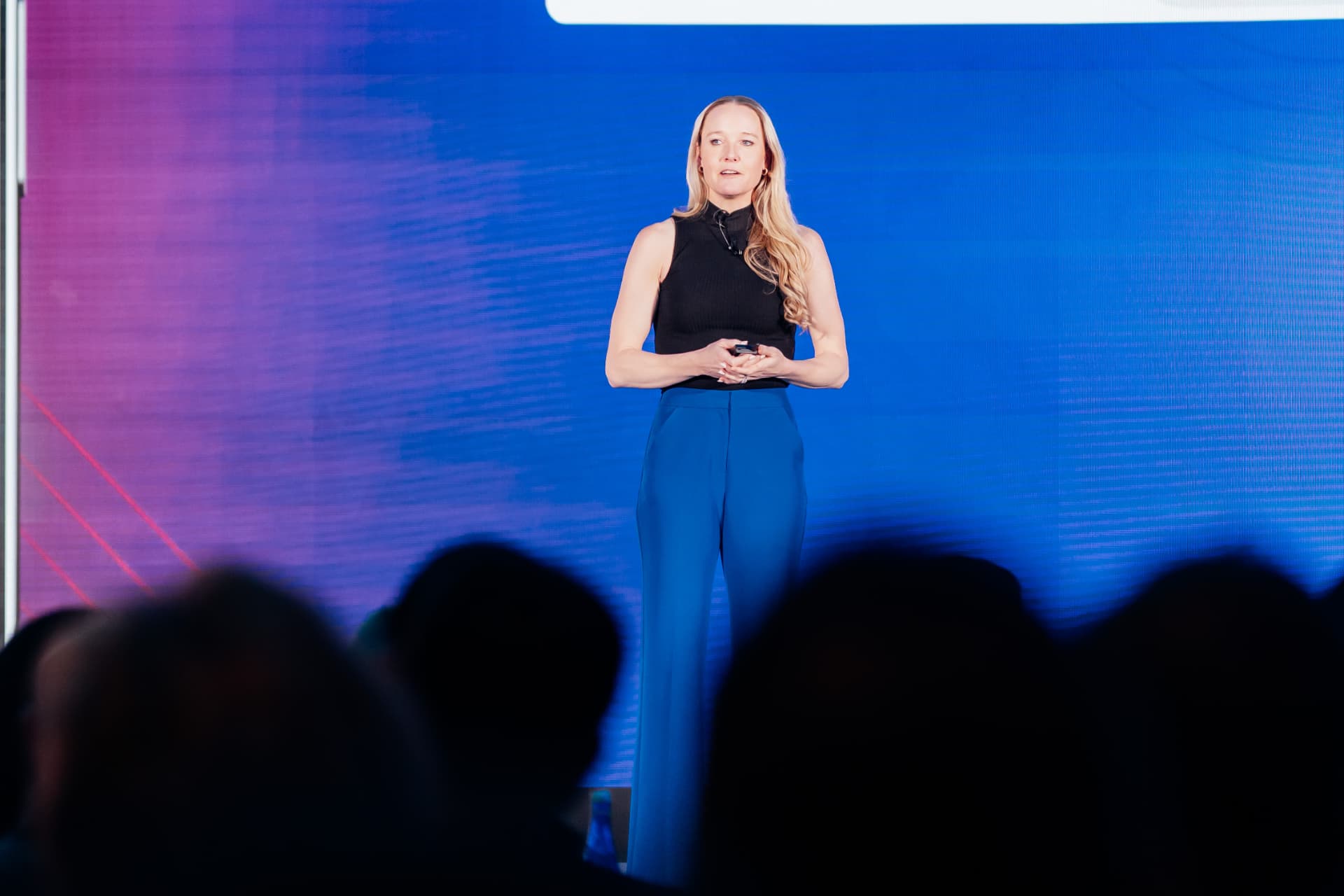 Corporate event photography of a keynote speaker presenting on stage at a Tampa corporate conference